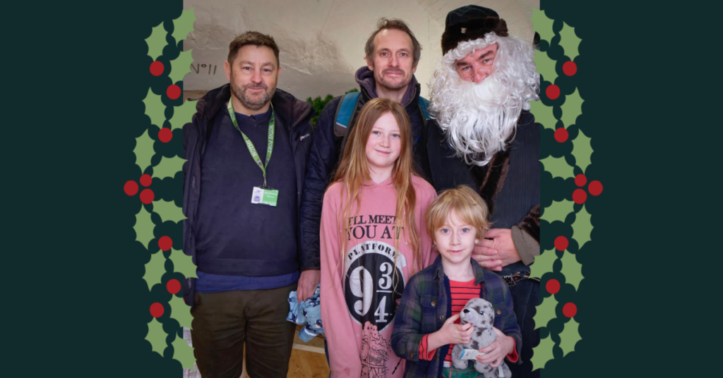 Image of our Chairman, our Father Christmas, and the 100,000th visitors to the Fort.