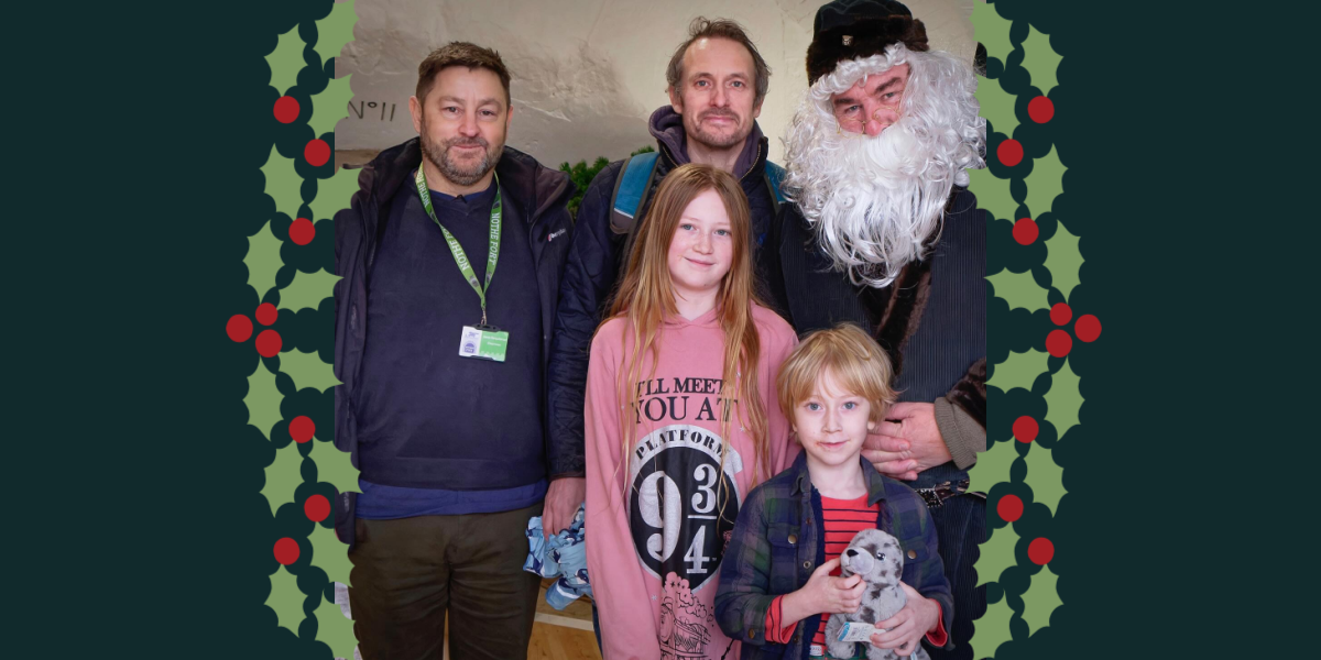 Image of our Chairman, our Father Christmas, and the 100,000th visitors to the Fort.