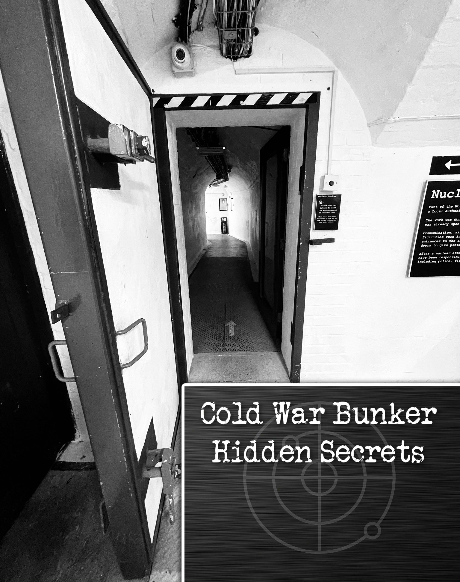 A black and white image of a thick metal door to an emergency nuclear bunker. The corridor beyond the door is dark, but there is a mysterious light at the end of the tunnel.