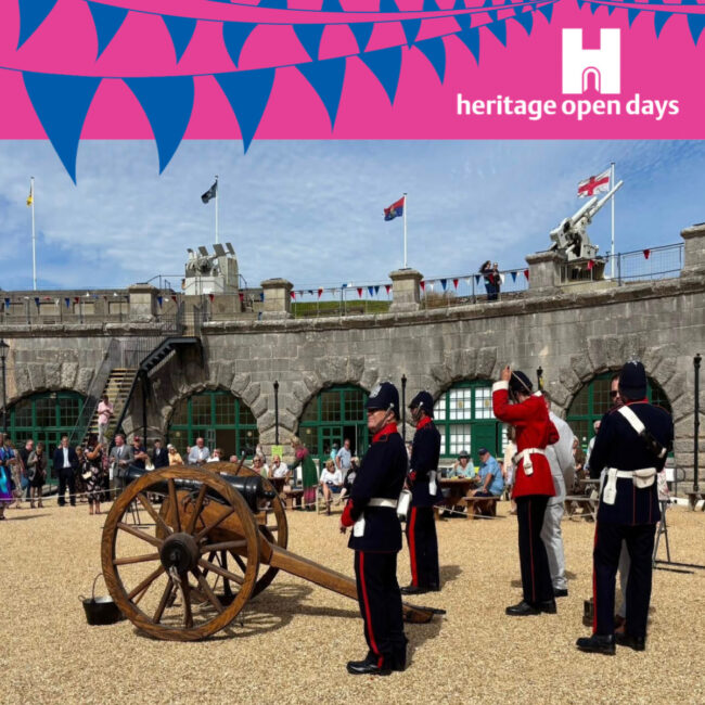Heritage Open Day A square image of a photo of the Artillery in Nothe Fort posing with their cannon. Above the blue sky of the image is a bright pink banner with blue bunting across the logo. In the right hand corner of the pink header is the white heritage open days logo.