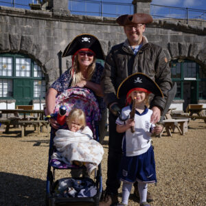 A family group of pirates standing in the Fort.