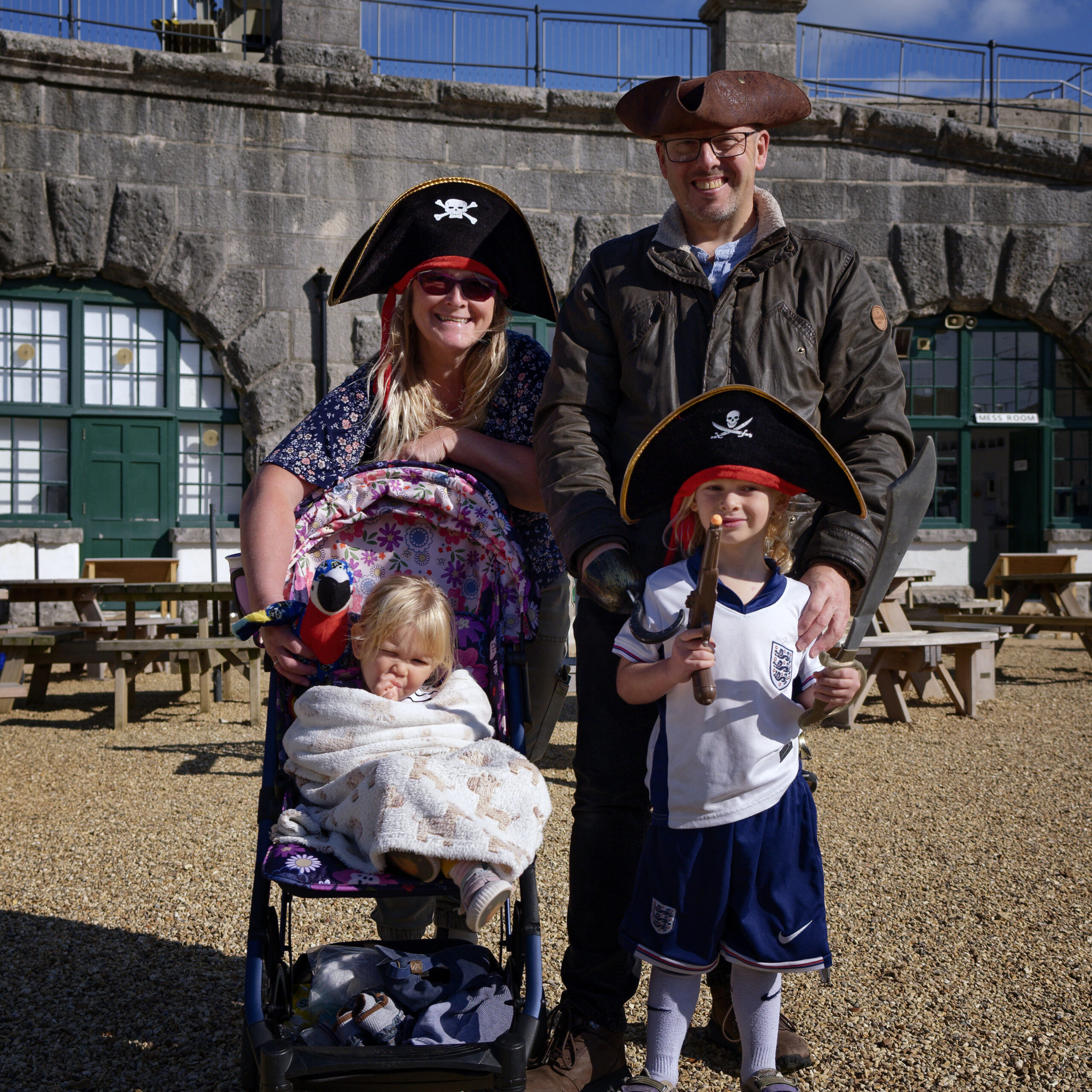 A family group of pirates standing in the Fort.