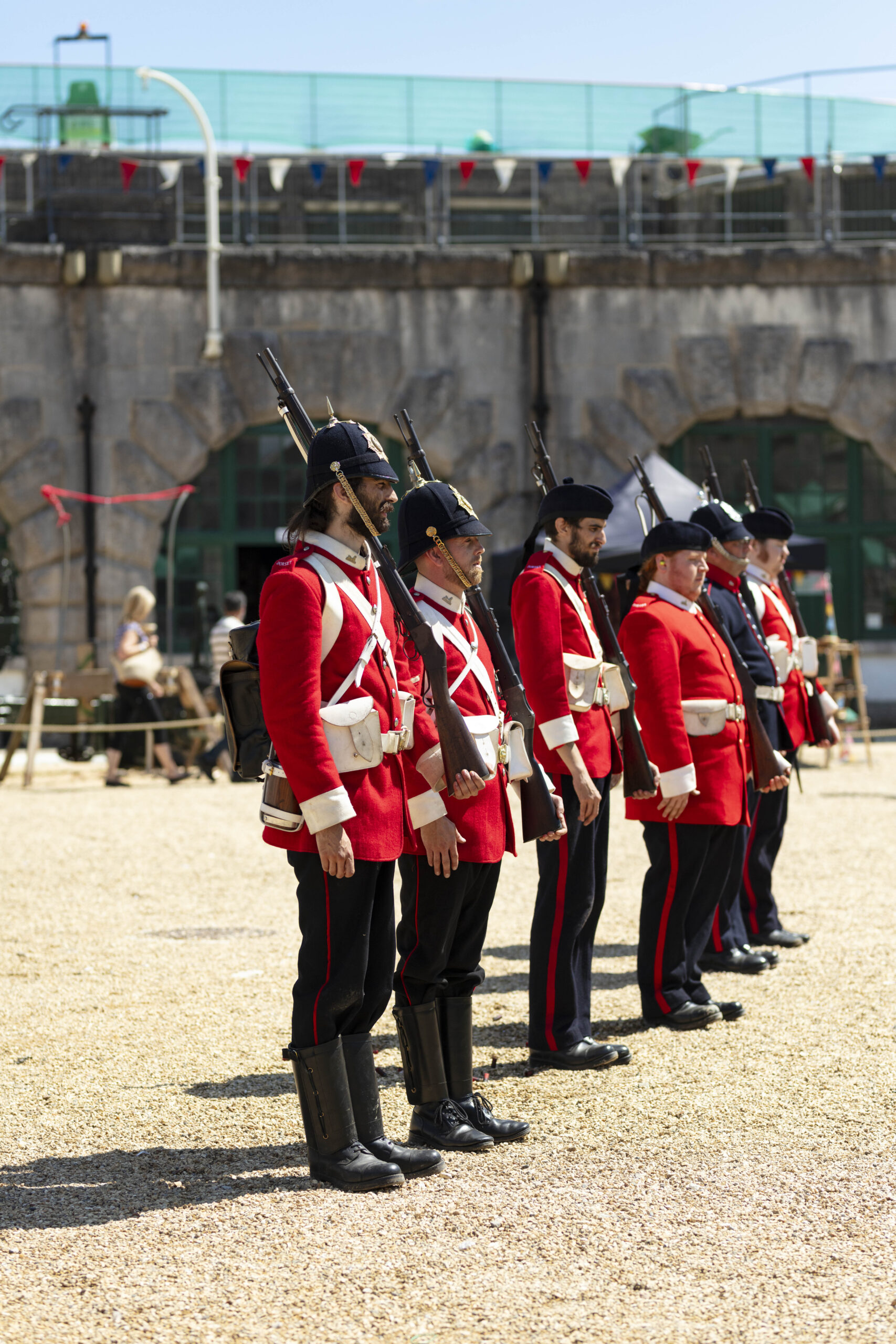 Nothe Fort Garrison A photo of the Nothe Fort Garrison The Dorsetshire Regiment posed holding their muskets in the Parade Ground. Their uniforms are bright red with black trousers and shiny polished black boots.