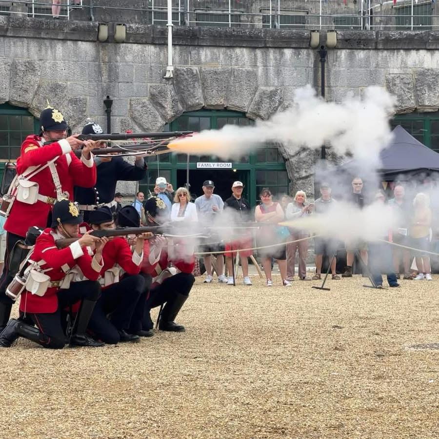A photo of the Nothe Fort artillery firing muskets in the parade ground.