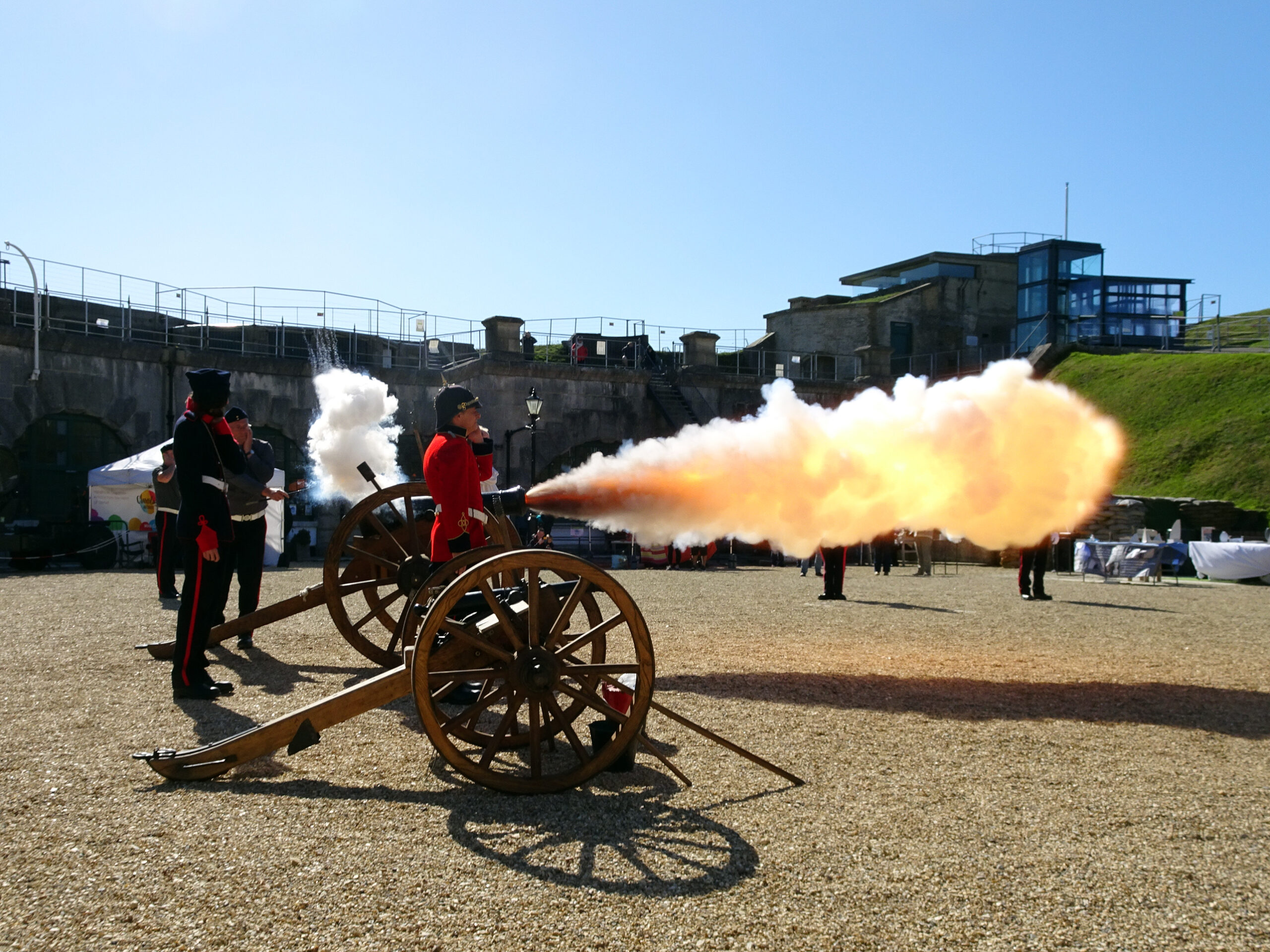 The Nothe Fort Artillery fire the cannon in the parade ground producing a bright cloud from the end of the cannon.