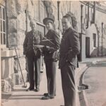 A black and white photograph of 3 soldiers stationed in the Fort during war time.