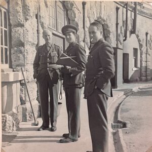 A black and white photograph of 3 soldiers stationed in the Fort during war time.