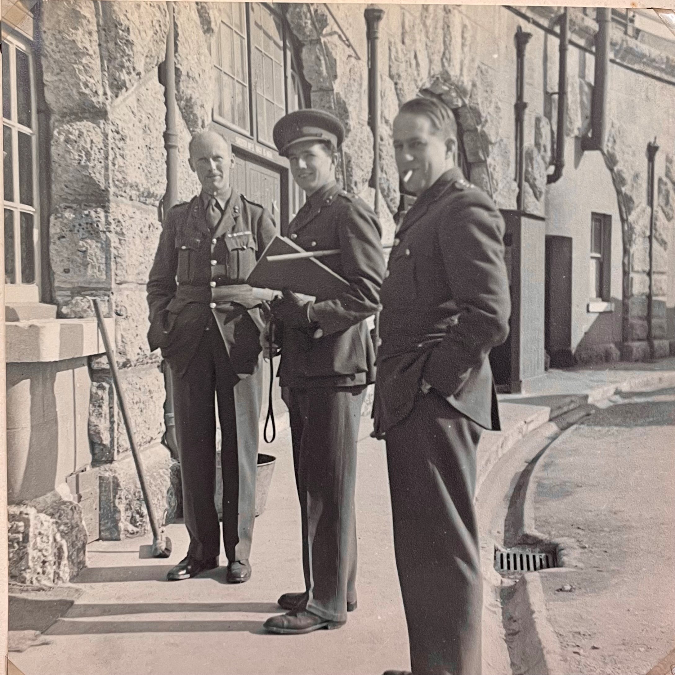 A black and white photograph of 3 soldiers stationed in the Fort during war time.