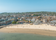 A large landscape drone photo of weymouth beach on a sunny day