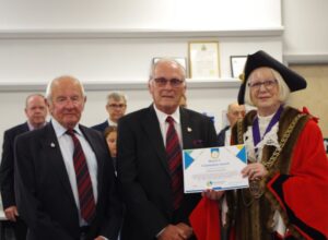 Two Nothe Fort volunteers accepting an award from the Weymouth Mayor